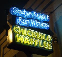 three neon signs on the side of a building that say chicken waffles and glade knight ron whanns