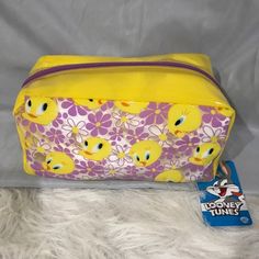 a yellow and purple bag with rubber ducks on it