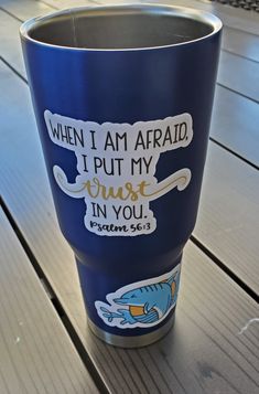 a blue cup sitting on top of a wooden table