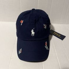 You're Buying a Polo Ralph Lauren Men's Navy Hat Nautical Embroidered Cap Classic baseball cap silhouette 6-panel construction with embroidered eyelets at the crown Seamed bill. Adjustable back strap with an antiqued nickel buckle Embroidered "Polo" at the center back. Ralph Lauren's signature embroidered pony accents the center front. Approx. 23 1/4 circumference Cotton Hand wash Imported. Brand new with tags Thank you & Happy Buying! Ralph Lauren Nautical, Custom Fitted Hats, Navy Hat, Navy Hats, Embroidered Cap, Navy Man, Embroidered Hat, Embroidered Caps, Embroidered Hats