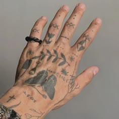 a person with tattoos on their hand holding something