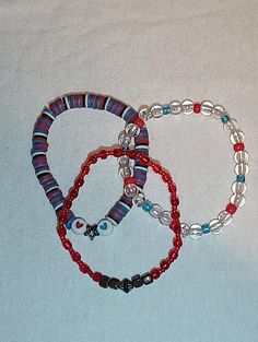 spiderman themed 3pts set stackable beaded bracelets  include :  1 blue, black, red, and white clay beaded with star and hearts  1 red sea bead bracelet  1 clear acrylic with red and blue sea beads bracelet Red Bracelet Ideas, Spider Man Bracelet, Spiderman Bracelet, Verse Bracelet, Sea Beads, Stackable Beaded Bracelets, Bracelet Inspo, Blue Beaded Bracelets, Red Bracelets