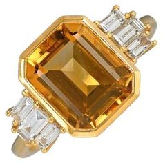 Elevate your style with this distinctive gemstone ring showcasing a bezel-set 3.30-carat emerald-cut natural citrine center stone. The shoulders are adorned with meticulously set baguette-cut diamonds, adding a touch of sophistication. Meticulously handcrafted in 18k yellow gold, this ring boasts a total approximate diamond weight of 0.42 carats. Ring Size: 6.5 US, Resizable Metal: Gold, Yellow Gold Stone: Diamond, Citrine Stone Cut: Emerald Cut Style: Art Deco Total Weight: 4.06 Grams Style Art Deco, Baguette Cut Diamond, Citrine Stone, Natural Citrine, Gold Stone, Art Deco Ring, Stone Cuts, Cocktail Ring, Cocktail Rings