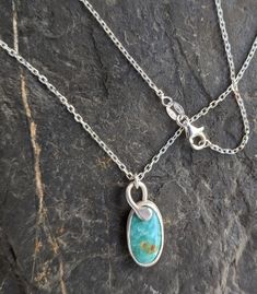 A beautiful Arizona turquoise bezel set cabochon finished on an 18-in sterling silver chain is the perfect necklace for every day! The beautiful color is accented by light brown matrix. Sterling Silver Teardrop Necklace With Bezel Setting, Dainty Sterling Silver Oval Necklace, Turquoise Oval Cabochon Jewelry For Gifts, Sterling Silver Turquoise Necklace With Cabochon, Sterling Silver Turquoise Oval Cabochon Jewelry, Turquoise Birthstone Necklaces In Sterling Silver, Turquoise Birthstone Necklace In Sterling Silver, Oval Turquoise Sterling Silver Jewelry, Handmade Turquoise Birthstone Necklaces In Sterling Silver