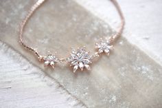 This delicate bridal bracelet features pretty crystal petals that effortlessly add a touch of shine to any look! - Bracelet has an adjustable slide clasp that will fit most wrist sizes - Available in rose gold, yellow gold and rhodium (silver) finishes - Handcrafted with high quality cubic zirconia Browse My Entire Shop For More Jewelry & Accessories: https://www.etsy.com/shop/TheExquisiteBride Browse My Shop For Earrings: https://www.etsy.com/shop/TheExquisiteBride?section_id=14483895 Brows Gold Jewelry Bridal, Gold Bridesmaid Bracelet, Simple Bridal Necklace, Rose Gold Statement Earrings, Bridesmaid Bracelet Gift, Gold Schmuck, Rose Gold Bridesmaid, Dainty Wedding, Backdrops Necklace