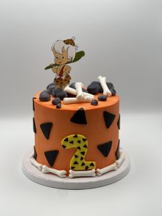 a birthday cake decorated with an orange and black theme