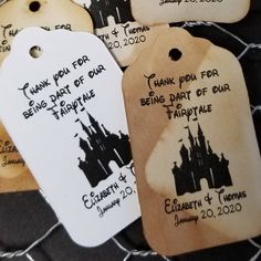 four tags with the names and dates of each disney world event are on a table