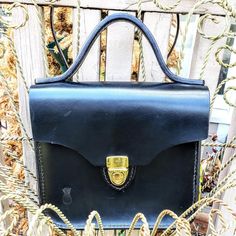 Black Sedgwick & Co. British Leather Top Handle Handbag. Style Kiawah. Gold Hardware. 7.5" X 8.5" X 2.5". Full-Grain Leather Has Character All Its Own Which Often Displays Natural Markings Lending Unique Beauty To The Leather Piece. Scapegrace Leather Designs Is A Maker Of Fine Leather Goods Designed And Handcrafted In Beautiful South Carolina. Timeless Evening Satchel With Brass Hardware, Formal Black Satchel With Brass Hardware, Formal Satchel With Brass Hardware And Tote Shape, Formal Tote Satchel With Brass Hardware, Formal Satchel Tote With Brass Hardware, Formal Satchel With Brass Hardware, Hello Kitty Makeup Bag, Mini Makeup Bag, Mini Backpack Purse