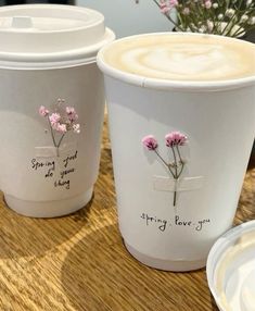 two white cups with pink flowers on them