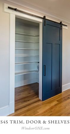 an empty room with blue doors and shelves