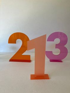 three different colored numbers sitting next to each other