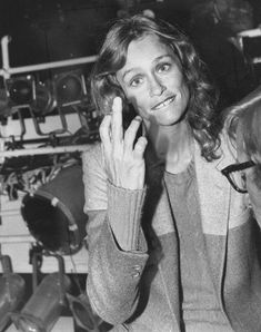 black and white photograph of a woman holding her hand up