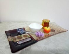 a tray that has some food on it and an apple in the bowl next to it