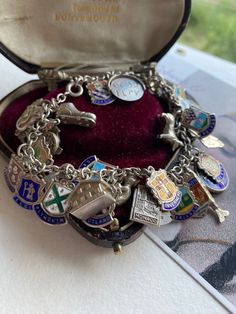 This is one big charm bracelet with 45 charms, many European crested enamel pieces and 17 Figural charms including two spinners, one says GOOD Luck, the other I LOVE you. The charms span from the 1950s to 1970s. My own particular favourite is the articulated fish with Ruby eyes.  Weight 73.3 Grams, Cable chain measuring 7 1/2". The longest charm is the fish. Charms are stamped Sterling, silver, argent, 800:and some are hallmarked. The charm fastens with a Spring ring, I have a small new Padlock Vintage Charm Bracelet 1stdibs, Affordable Silver Bracelet With Vintage Charm, Cheap Vintage Charm Bracelet, Cheap Vintage Bracelets With Charms, Cheap Silver Charm Bracelet With Vintage Charm, Luxury Heirloom Style Bracelets With Vintage Charm, Luxury Metal Charm Bracelet With Vintage Charm, Vintage Charm Bracelet Silver, Antique Charm Bracelet As Gift