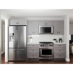 a kitchen with gray cabinets and stainless steel appliances