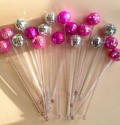 pink and silver disco ball lollipops are lined up