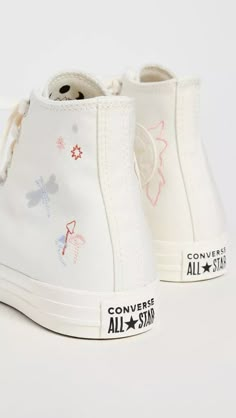 The Chuck Taylor All Star combines retro style with modern flair. Featuring canvas uppers adorned with embroidered wings and floral accents, as well as a glittering dragonfly aesthetic, these sneakers bring a unique sense of whimsy to any outfit. A round toe and lace-up closure provide custom fit and comfort, while the lightly cushioned lining and durable rubber sole ensure all-day wearability. An Instagram-worthy sneaker and staple, reimagined for the fashionably eclectic. Embroidered Shoes Converse, Pink Chuck Taylors, Cute Converse Shoes, Womens High Top Shoes, Cute Converse, Converse Custom, All Star Sneakers, Chuck Taylor All Star Lift, Dr Shoes