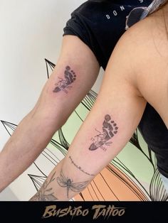 two people with matching tattoos on their arms