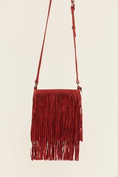 Suede leather upper Zipper closure Adjustable shoulder strap Solid red design Fringe accent Zippered pocket on interior Imported Crossbody styling Red Crossbody Shoulder Bag With Detachable Strap, Red Bag With Long Strap For Daily Use, Red Rectangular Bag With Long Strap, Red Rectangular Bag With Fringe, Red Crossbody Satchel With Adjustable Strap, Red Shoulder Bag With Adjustable Strap, Red Satchel With Adjustable Strap Crossbody, Red Satchel Shoulder Bag With Adjustable Strap, Fringe Crossbody Bag