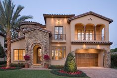 a large house with two garages and lots of windows