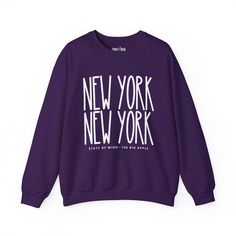 Elevate your urban style with our "New York New York Chic" Women's Sweatshirt, designed for those who appreciate the dynamic energy of the city that never sleeps. Embrace the essence of New York's iconic fashion scene while enjoying unparalleled cozy comfort. Crafted from premium materials, this sweatshirt is more than just a garment; it's a statement piece. The intricate design seamlessly integrates the bold "New York New York" lettering, showcasing your love for the city's vibrant spirit. The Trendy Purple Sweater For Streetwear, Urban Slogan Tops For Fall, Trendy Purple Sweatshirt With Graphic Print, Winter Athleisure Top With Text Print, Athleisure Winter Top With Text Print, Urban Purple Letter Print Top, Urban Winter Tops With Slogan, Urban Winter Tops With Text Print, Winter Streetwear Sweater With Lettering