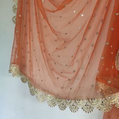 Long Net Embroidered dupatta with golden border and kundan embroidery. These are very much in trend now. Pair it with plain kurta to make your dress unique. Perfect gift item also. Beautiful net with scallop border dupatta. It has light golden border Mix and match with our skirts and blouses. Or we can make something for you to match this. Hand wash and hang to dry. You can press or steam this on a gentle setting. Note: There may be slight color variation due to different display settings on you Gold Traditional Wear With Embroidered Border, Semi-stitched, Festive Gold Sharara With Embroidered Border, Gold Anarkali Set With Mirror Work For Diwali, Unstitched Gold Traditional Wear With Embroidered Border, Gold Dola Silk Sharara With Sheer Dupatta, Gold Sharara With Embroidered Border For Eid, Gold Traditional Wear With Embroidered Border For Festivals, Gold Kundan Anarkali Set With Dupatta, Festive Gold Traditional Wear With Embroidered Border