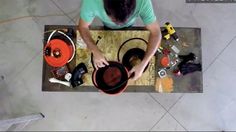 a man in green shirt working on a hat