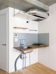 an empty kitchen with a sink and stove