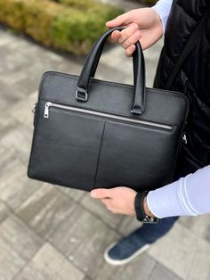 Laptop Bag "Collide", Luxury Leather Briefcase, Black Messenger Bag, Men's Traveling Port, Slim Rucksack, Notebook Bag, Laptop Case, Satchel ∎ Material: genuine leather ∎ A strap is included ∎ 2 main departments ∎ 1 additional department ∎ 1 zipped pocket in the middle ∎ 1 Compartment inside for laptop/things ∎ Additional 2 small pockets inside ∎ Height: 30 cm / 11.8 in, ∎ Length: 38.5 cm / 15.2 in, ∎ Width: 6 cm / 2.4 in This handmade genuine leather bag is made from traditional leather. The ba Black Briefcase Backpack For Office, Black Business Backpack Satchel, Black Leather Rectangular Backpack With Laptop Sleeve, Modern Black Briefcase For School, Black Briefcase With Adjustable Strap And Backpack Shape, Black Leather Backpack With Laptop Sleeve, Black Briefcase Backpack With Adjustable Strap, Black Tote Briefcase For School, Black Briefcase With Adjustable Strap