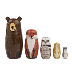 there are five wooden owls and a bear