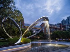 a fountain in the middle of a park at night