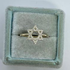 Simple Star of David Ring Yellow Gold.  Wear this dainty Star of David Ring on any finger.  Sits low on the finger.  The diamonds are nice and sparkling.   Star of David measures about 11.1 x 9.2mm.  Band is about 1.1mm width. Genuine Round Brilliant cut diamonds  Total weight: 0.16 Carats Clarity: I Color: G Solid 14K yellow gold  stock ring size 6.5 comes with gift box  * We have been in the wholesale Jewelry business for over 30 years serving the community at the same location.  All diamonds Star-shaped Brilliant Cut Diamond Ring, Star-shaped Diamond Ring With Single Cut Diamonds, Star-shaped Single Cut Diamond Ring, 14k Gold Star-shaped Diamond Ring With Single Cut Diamonds, Star-shaped 14k Gold Diamond Ring, Star-shaped Yellow Gold Diamond Ring, Vvs Clarity Star-shaped Diamond Ring, Star-shaped Promise Ring With Diamond Accents, Star-shaped Diamond Ring With Single Cut Diamonds For Wedding