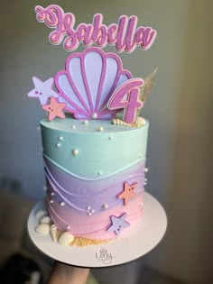 there is a cake that has been decorated with stars and seashells on it