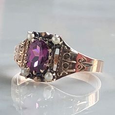 Details: Beautiful Victorian Garnet and Seed Pearl ring set in lovely 14K rose gold. The band is adorned in lovely abstract filigree engraving. The stone has great depth, and has a lovely rich pink tint to the garnet. It is surrounded by 4 seed pearls. The garnet measures 7.5mm x 5mm. There are no internal markings. Measurements: Ring measures a size 7 3/4 US. It can be re-sized for a fee. Condition: The overall all condition of this ring is very good. Please ask all questions prior to placing a Elegant Rose Gold Engraved Ring Stamped 14k, Ornate Hallmarked Rose Gold Jewelry, Victorian Hallmarked Rose Gold Ruby Ring, Victorian Rose Gold Ruby Ring Hallmarked, Elegant Hallmarked Rose Gold Ring, Elegant Pink Jewelry With Engraving, Ornate Rose Gold Jewelry For Anniversary, Elegant Rose Gold Hallmarked Rings, Formal Pink Gold Jewelry With Rose Cut Diamonds