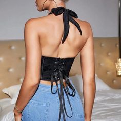 Make a bold statement with our black floral embroidered corset top, designed with a captivating halter neck. The artistic embroidery adds a feminine touch, while the lace-up back detail brings in a modern twist. This top offers both comfort and flexibility, ideal for any occasion where you want to turn heads. Wear it solo with high-waisted pants or layer it under a blazer for a polished look. Elevate your fashion game with this uniquely stylish piece. Color: BlackNeckline: HalterSilhouette: Shea Fitted Crop Top With Lace-up Back For Party, Elegant Black Backless Corset, Black Party Corset With Lace-up Back, Gothic Corset For Spring, Black Backless Corset With Boned Bodice, Fitted Backless Top With Corset Back, Black Spring Gothic Corset, Chic Black Backless Corset, Lace-up Backless Top