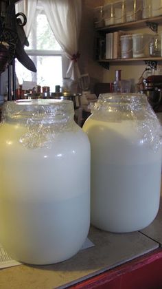 two large jugs sitting on top of a counter next to each other in a kitchen