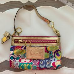 Looks Brand New. See Pictures. Multicolor Retro Coach Bag, Multicolor Coach Bags With Gold-tone Hardware, Coach Multicolor Bags With Gold-tone Hardware, Chic Coach Bag With Zipper Pouch, Coach Multicolor Clutch Bag, Multicolor Coach Clutch Bag, Trendy Multicolor Coach Shoulder Bag, Multicolor Coach Bag With Zipper Closure, Multicolor Crossbody Bag With Gold-tone Hardware