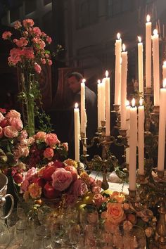 a table topped with lots of candles and flowers