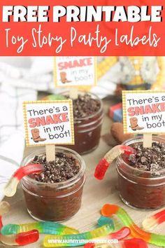 three small jars filled with chocolate pudding on top of a wooden table next to candy