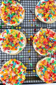 four desserts on a cooling rack with sprinkles and colored candies