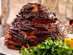 a large piece of meat sitting on top of a plate next to some parsley