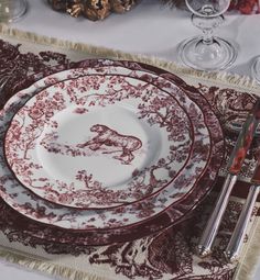 the table is set with red and white china