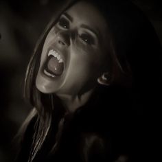 a woman with her mouth open in the dark