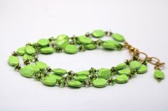 Take your style up a notch with this dramatic Lime Statement necklace. Three luscious strands of yellow, lime, and turquoise beads are combined with sparkling Swarovski© Crystal. The green glass swirl and copper seed beads to create a look that's sure to turn heads. The gold-colored chain is 16 to 19 inches in length, weighs 2 oz - making it perfect for any outfit. With its beautiful colors and eye-catching design, the Lime Statement necklace is sure to become one of your favorite accessories. Green Beaded Chain Bracelet For Jewelry Making, Green Beaded Chain Bracelets For Jewelry Making, Green Multi-strand Beads For Gifts, Green Beaded Chain Jewelry, Green Double Strand Beaded Chain Necklace, Green Multi-strand Necklace With Colorful Beads, Green Polished Beads Jewelry For Party, Green Multi-strand Polished Beaded Necklace, Green Multi-strand Beads For Jewelry Making