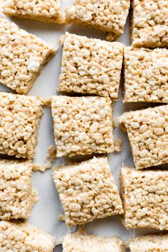 several squares of rice krispy treats on a white surface