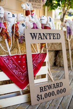 there is a sign that says wanted reward $ 1 00, 000 in front of some stuffed animals