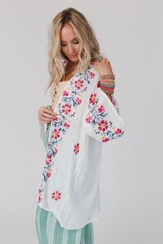 Elevate all of your favorite boho outfits with the Waikiki Beach Embroidered Kimono! This kimono is a true show - stopper, sure to get compliments when worn because it features Lightweight and flowy woven fabric with a relaxed and loose kimono silhouette Classic open front closure allows you to show off your favorite outfits underneath Long and loose kimono sleeves Stunning embroidered floral details throughout Classic boho outfit pair with: High Neck Racerack Brami, Billy Corduroy Pants, Over T White Boho Print Kimono For Beach Cover-up, Embroidered V-neck Kimono For Spring, White V-neck Kimono For Vacation, White Cotton Spring Cover-up, Spring White Cotton Cover-up, White V-neck Bohemian Kimono, Spring Tunic Kimono For Loungewear, Spring Loungewear Tunic Kimono, White V-neck Kimono For Festival