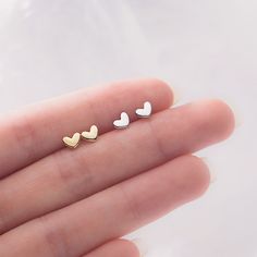 ♡ 925 Sterling Silver Tiny Minimalist Heart Stud Earrings, Dainty Heart Girl Earrings, Gold Plate Heart Earrings, Delicate Studs Earrings ♡ W H Y ∙ Y O U ' L L ∙ L O V E ∙ I T • They are beautiful studs that can be worn every day with any outfit • A special piece you will cherish • High quality materials and attention to even the minor details C H E R R Y ∙ T E R R A R I U M ∙ E A R R I N G S • Material: 925 Sterling Silver or 14K Gold Plated • Dimensions: ~ 0.13 x 0.13 inch • Ethically Sourced Earrings Pack, Trendy Stud Earrings, Teen Jewelry, Minimalist Earrings Studs, Silver Heart Earrings, Casual Tees, Tiny Studs, Heart Stud Earrings, Heart Shaped Earrings