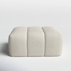 three white cushions sitting on top of each other