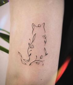 a woman's thigh with a tattoo of a cat on it